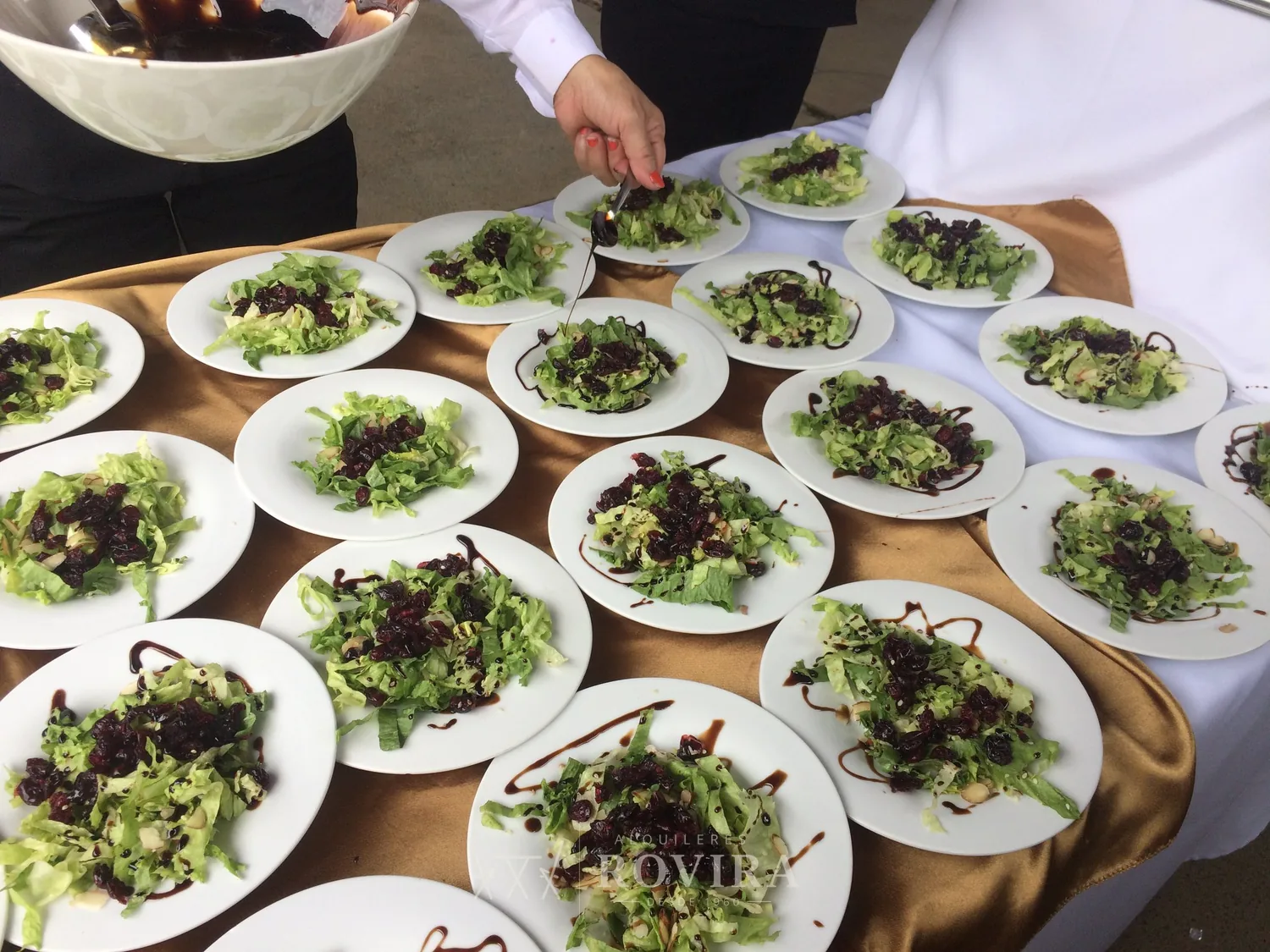 Ensaladas servidas en platos medianos en fila, servicio de catering